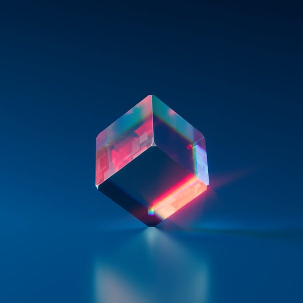 A multicolored cuble in the middle of a dark blue enviroment